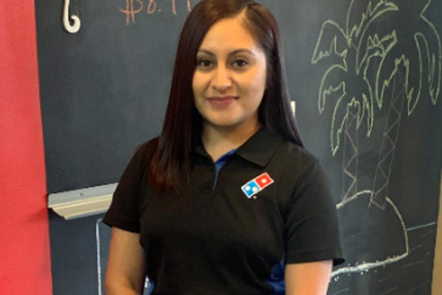 a woman standing in front of a chalkboard