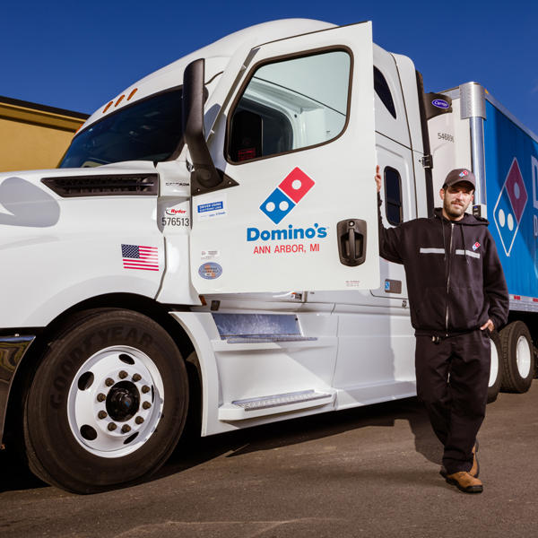 a man standing next to a truck