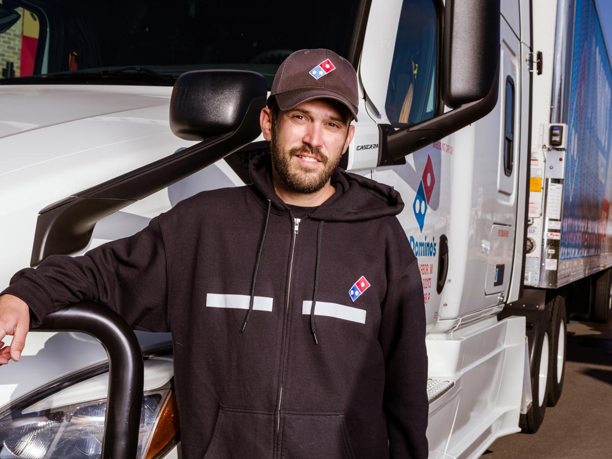 a man standing next to a truck