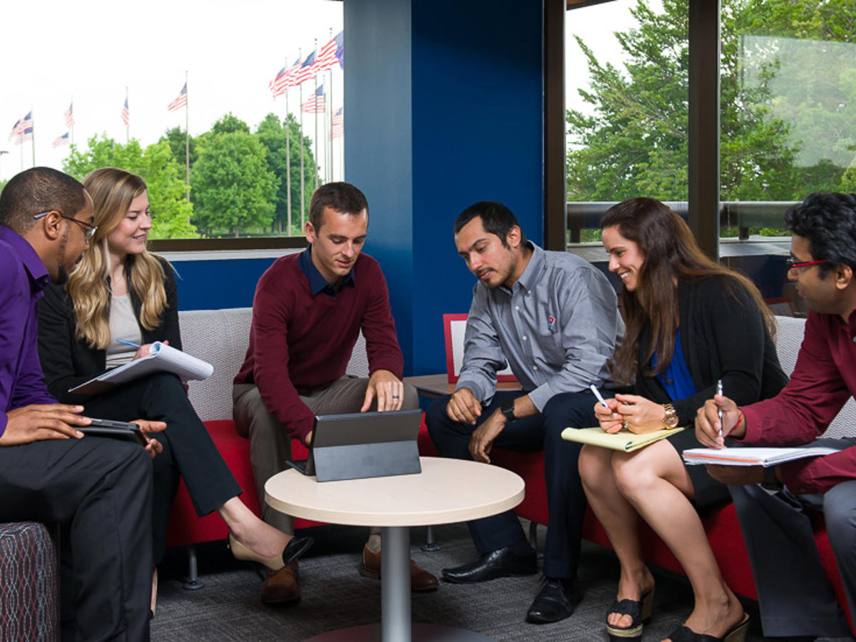 a group of people sitting around a table