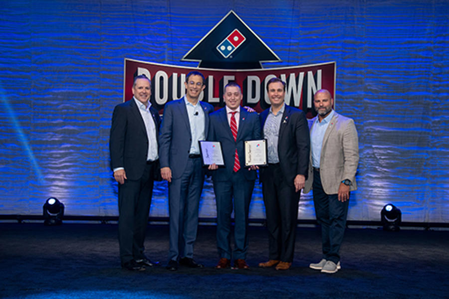 a group of men standing together with awards