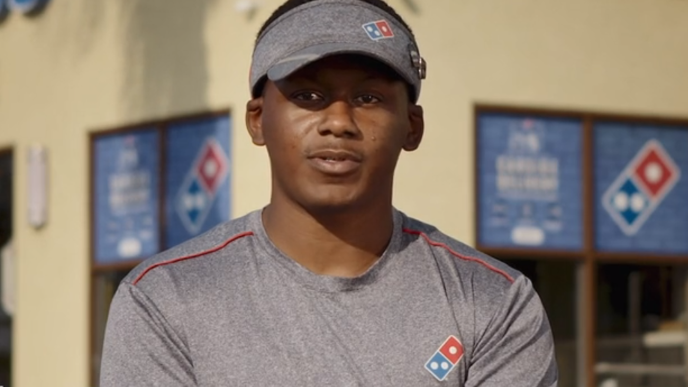 a man wearing a grey shirt and a visor