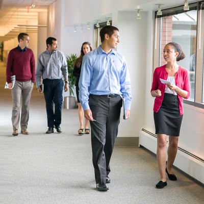 a group of people walking in a hallway