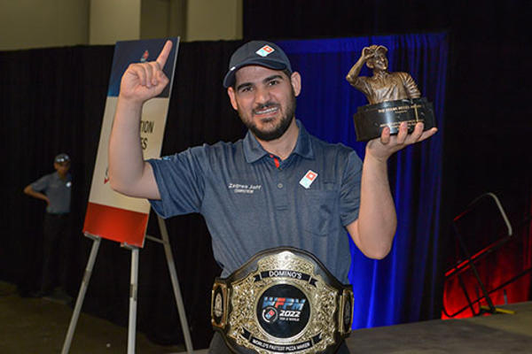 a man holding a trophy and pointing up