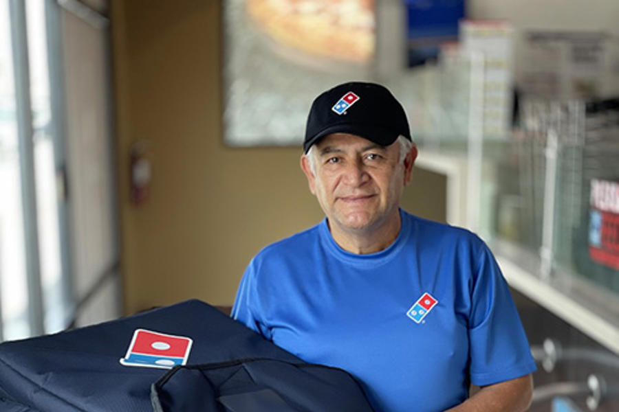 a man holding a pizza delivery bag