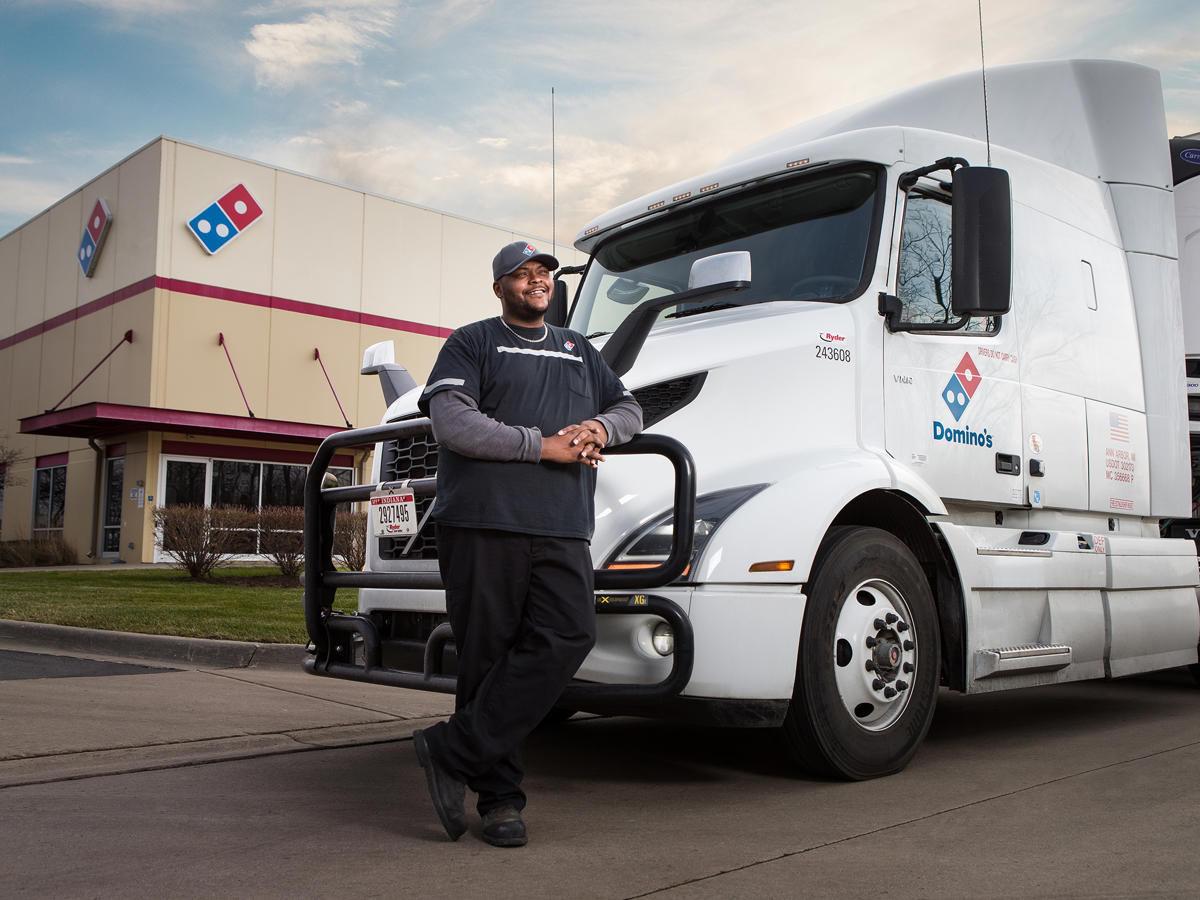 a man standing next to a truck