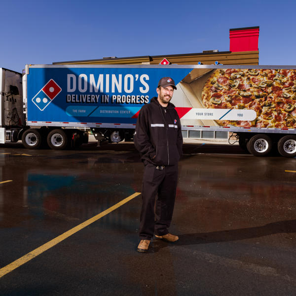 a man standing in front of a delivery truck