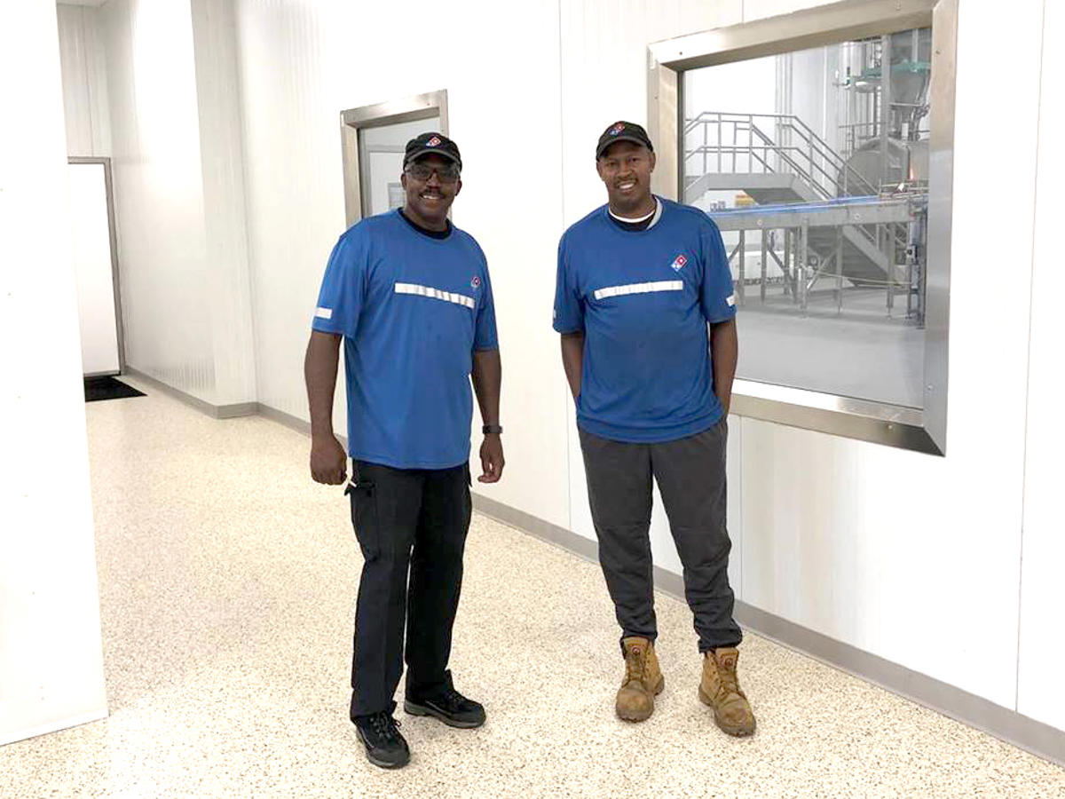 two men standing in a room